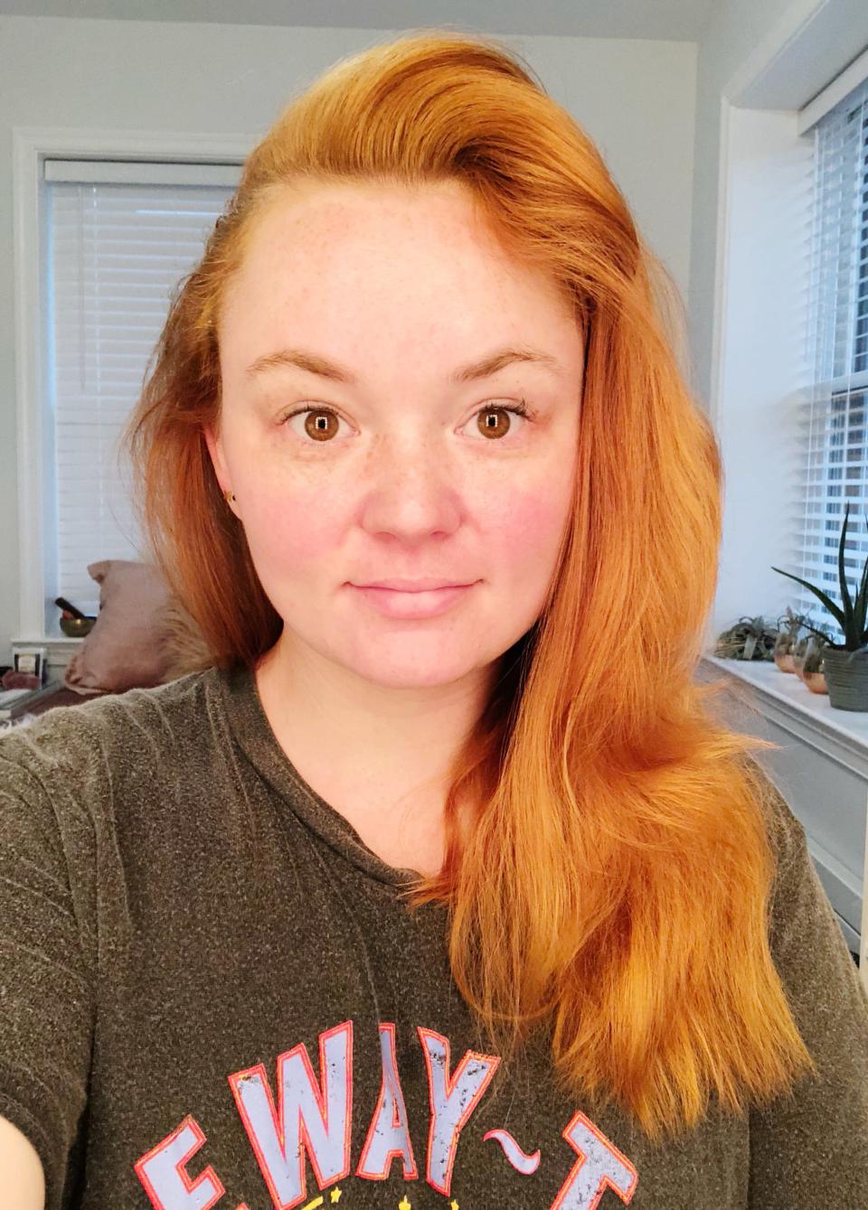 Girl with red hair and no makeup on.