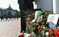 Ukrainian police march past a memorial set-up in front of the parliament building in Kiev, on September 1, 2015