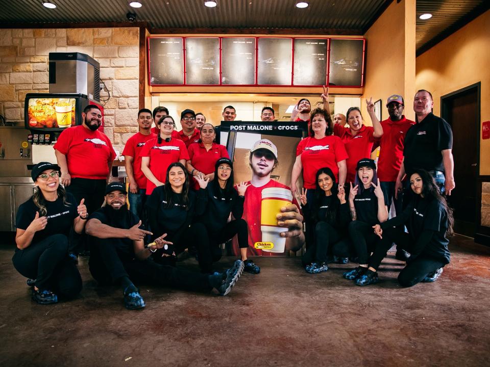 Chicken Express employees with a picture of young Post Malone.