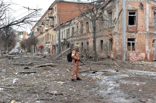 A member of the Ukrainian Territorial Defense Forces looks at destruction following a shelling in Ukraine's second-biggest city, Kharkiv, on Monday. (Photo: SERGEY BOBOK via Getty Images)