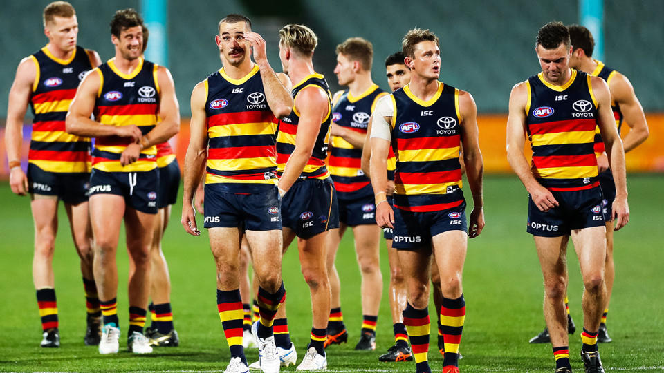 The Adelaide Crows are pictured walking off the field after their loss to St Kilda.