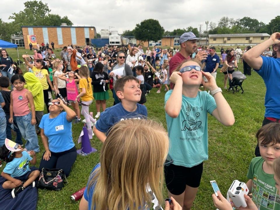 Cordelia Petersen gets a glimpse of the eclipse at Reilly Elementary