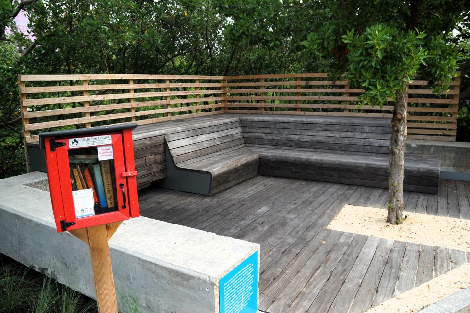 A shaded area for reading at The Bay Park provides a take-one, leave-one library nook.