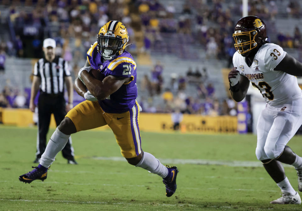 LSU running back Corey Kiner (21) runs past Central Michigan linebacker Kumehnnu Gwilly (33) for a touchdown during the fourth quarter of an NCAA college football game in Baton Rouge, La,. Saturday, Sept. 18, 2021. (AP Photo/Derick Hingle)