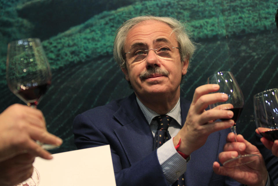 Sicily region governor Raffaele Lombardo tastes a glass of red wine at the 46th edition of the annual International Wine and Spirits Exhibition "Vinitaly", in Verona, northern Italy, Monday, March 26, 2012. "The companies show that by defeating the Mafia you can begin to legally produce wines, oil and high-quality agricultural goods in the interest of the workers and the producers," Sicily's governor Raffaele Lombardo told The Associated Press at Vinitaly on Monday. (AP Photo/Luca Bruno)