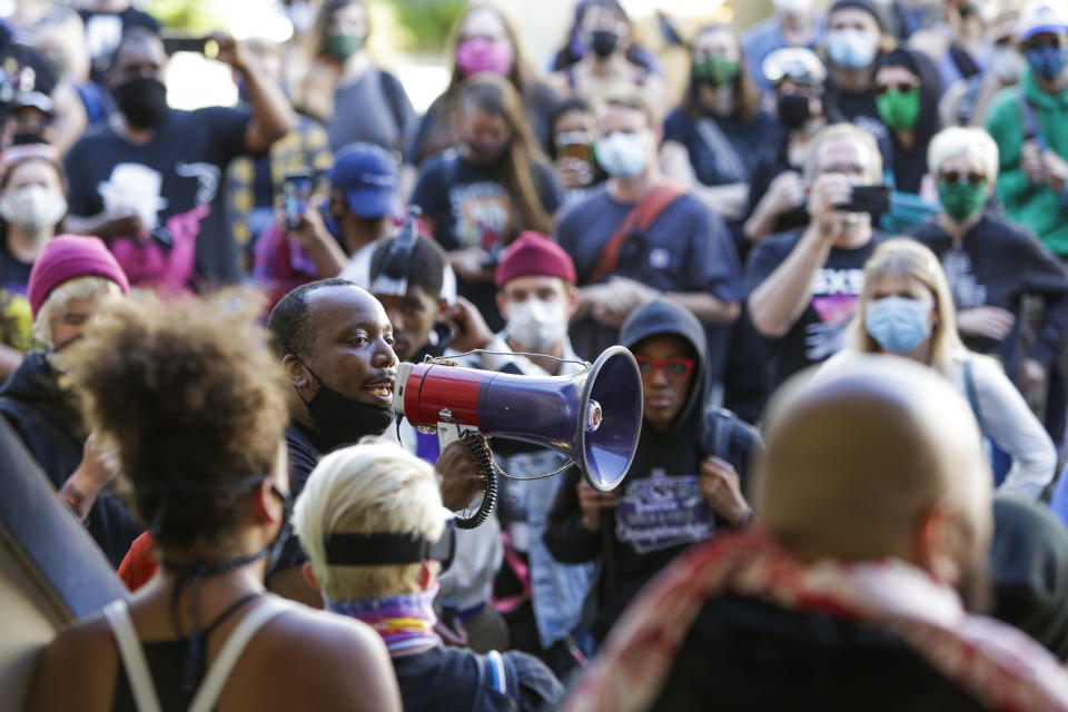 Mark Henry Jr. of Black Lives Matter addresses a crowd in an area being called the Capitol Hill Autonomous Zone (CHAZ) located on streets that reopened to pedestrian traffic after Seattle Police closed the East Precinct, in Seattle, Washington on June 11, 2020. - The area surrounding the East Precinct building has come to be known as the CHAZ, Capitol Hill Autonomous Zone. Volunteer medics are available to tend to medical needs, alongside tents with medical supplies, gourmet food donated form local restaurants, fruit, snacks, water bottles free for whomever needed them. (Photo by Jason Redmond / AFP) (Photo by JASON REDMOND/AFP via Getty Images)