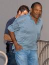 <p>O.J. Simpson is escorted from Las Vegas Metropolitan Police offices as he is taken to the Clark County Detention Center in Las Vegas, Nev., Sept. 16, 2007. Former football star Simpson, who was acquitted in 1995 of murdering his ex-wife, has been arrested in connection with an alleged armed robbery in a hotel room in Las Vegas. (Photo: Las Vegas Sun/Steve Marcus/Reuters) </p>