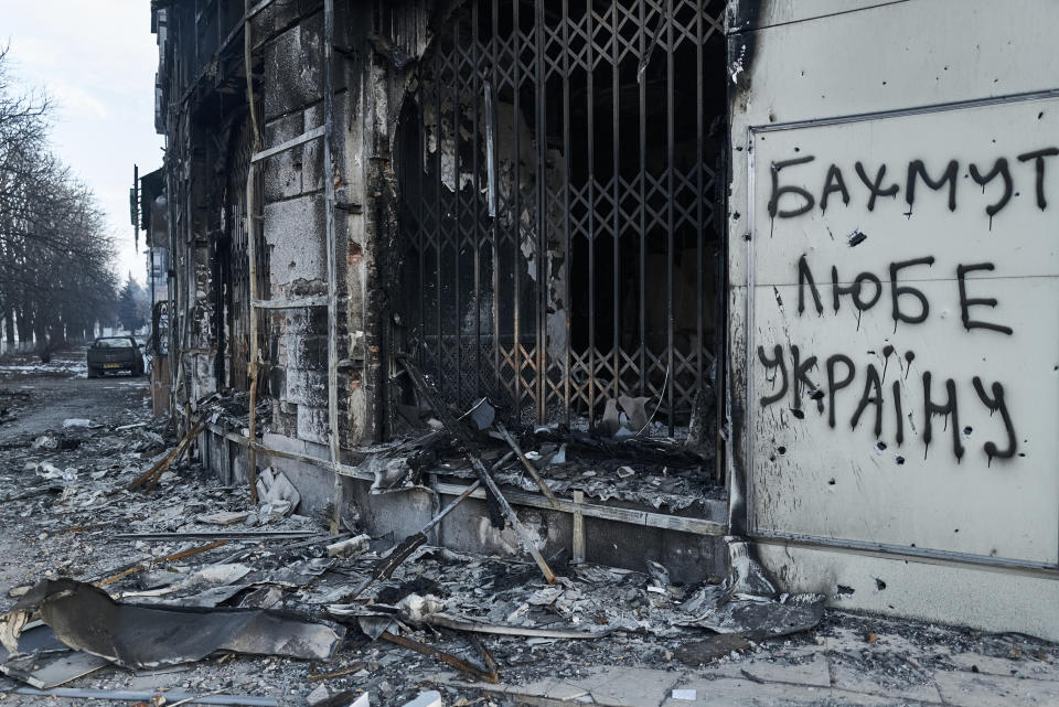 The city center damaged by Russian shelling in Bakhmut, Donetsk region, Ukraine, Friday, Feb. 10, 2023. Writing on the wall reads " Bakhmut loves Ukraine". (AP Photo/Libkos)