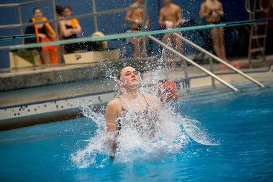 Hope's Abby Koops dives off the 1 meter platform during the MIAA Finals Thursday, Feb. 16, 2023, at Calvin University. 