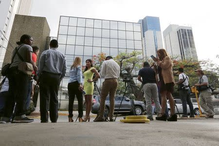 Members of the media stand outside the Mossack Fonseca law firm office in Panama City April 12, 2016. REUTERS/Carlos Jasso