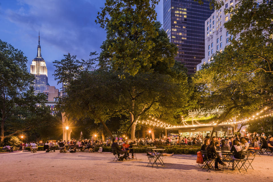 People dining outside in a park in NYC.