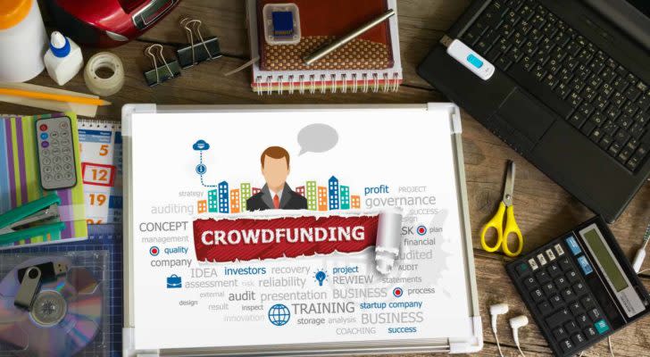 an image of the words crowdfunding on a tablet on a table. invest in startups