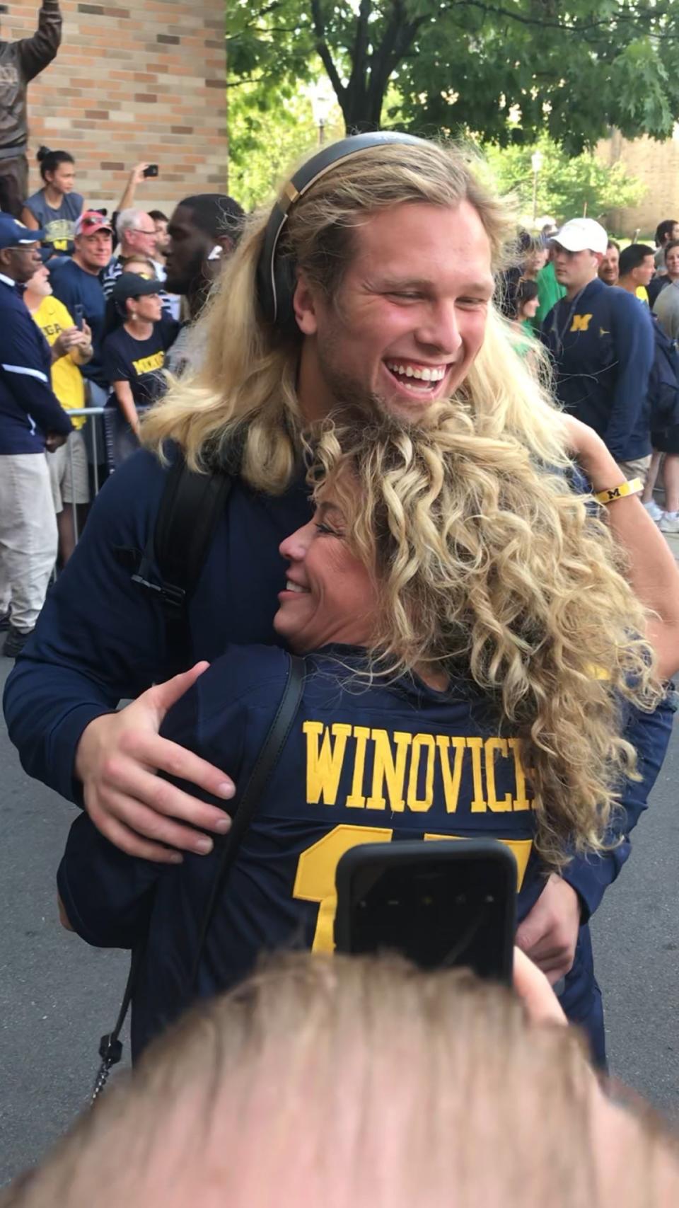 Michigan defensive end Chase Winovich hugs his mother, Anina, before one of his college football games.