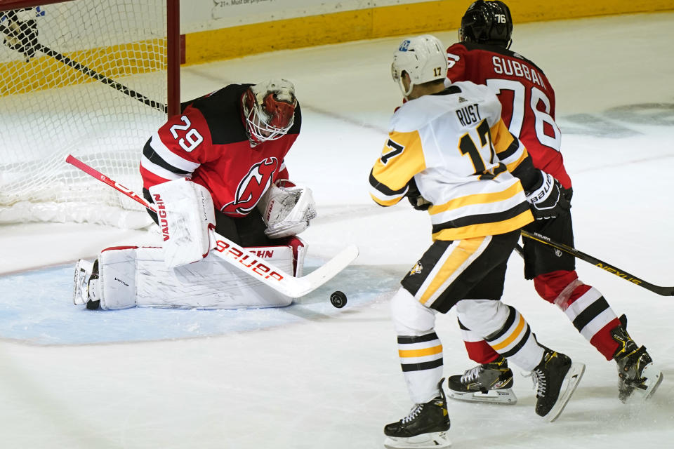 New Jersey Devils goaltender Mackenzie Blackwood (29) makes a save with New Jersey Devils defenseman P.K. Subban (76) fending off Penguins right wing Bryan Rust (17in front of the crease during the second period of an NHL hockey game, Sunday, April 11, 2021, in Newark, N.J. (AP Photo/Kathy Willens)