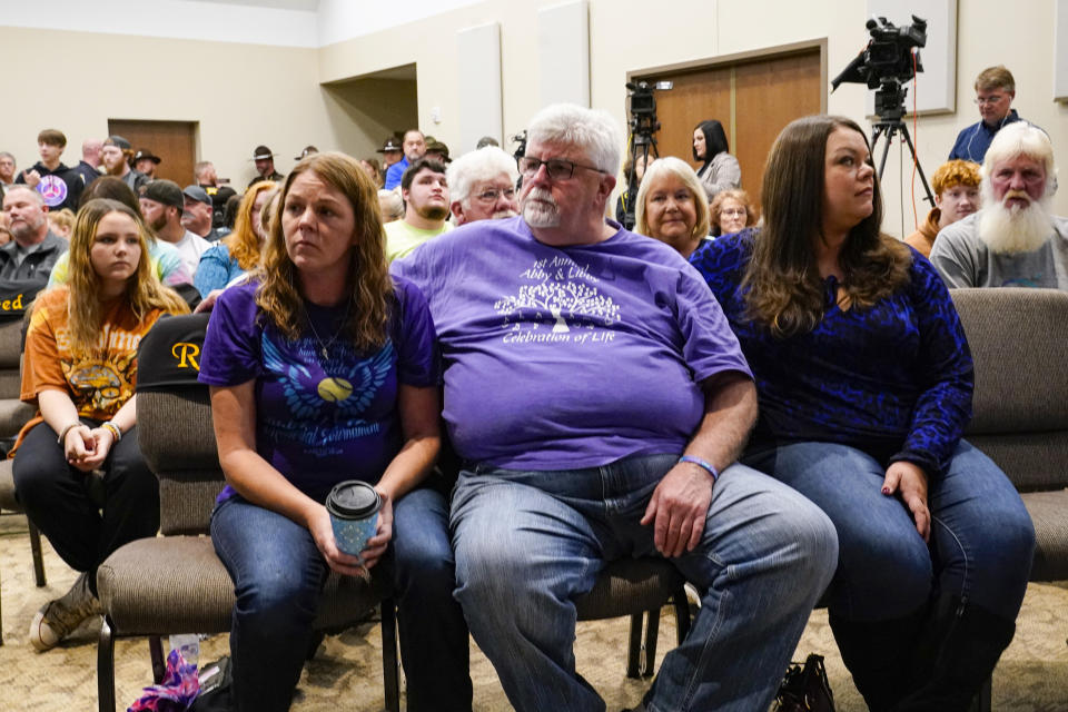 Family members of Liberty German, and Abigail Williams listen as Indiana State Police Superintendent Doug Carter announces during a news conference in Delphi, Ind., Monday, Oct. 31, 2022, the arrest of Richard Allen, 50, for the murders of two teenage girls killed during a 2017 hiking trip in northern Indiana. German, 14, and and Williams, 13, were killed in February 2017. (AP Photo/Michael Conroy)