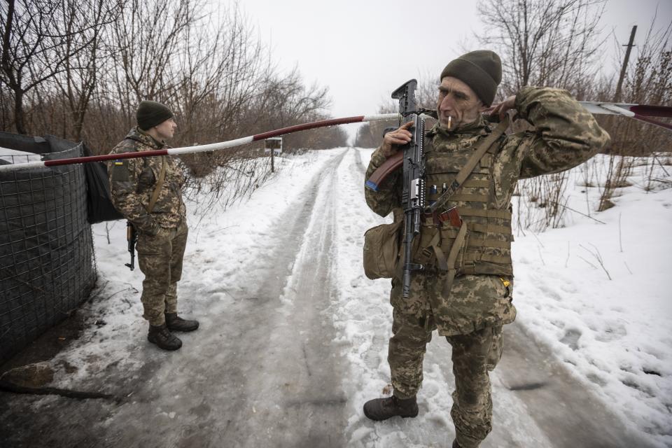 Ukrainian servicemen guard a checkpoint at the line of separation in the Luhansk region, in Luhansk, Ukraine, Thursday, Feb. 3, 2022. When the U.S. and NATO rejected the Kremlin's security demands over Ukraine last week, fears of an imminent Russian attack against its neighbor soared. (AP Photo/Andriy Dubchak)