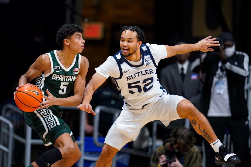 Michigan State guard Max Christie looks to pass around Butler guard Jair Bolden in the first half in Indianapolis, Wednesday, Nov. 17, 2021.