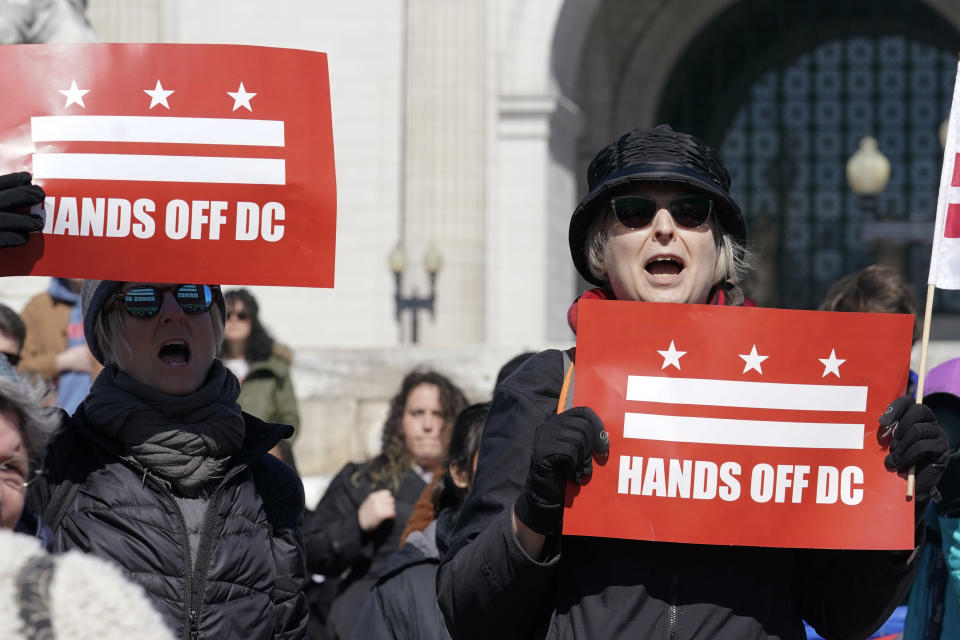 Demonstrators hold signs during the protest Wednesday, March 8, 2023, in Washington. Protestors rallied against a Republican-sponsored resolution blocking new District of Columbia laws that would overhaul how the nation's capital prosecutes and punishes crime. (AP Photo/Mariam Zuhaib)