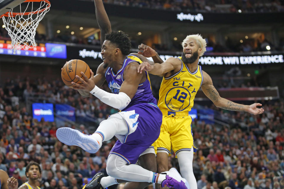 Utah Jazz guard Donovan Mitchell, left, goes to the basket as Golden State Warriors guard Ky Bowman (12) defends during the second half during an NBA basketball game Friday, Nov. 22, 2019, in Salt Lake City. (AP Photo/Rick Bowmer)