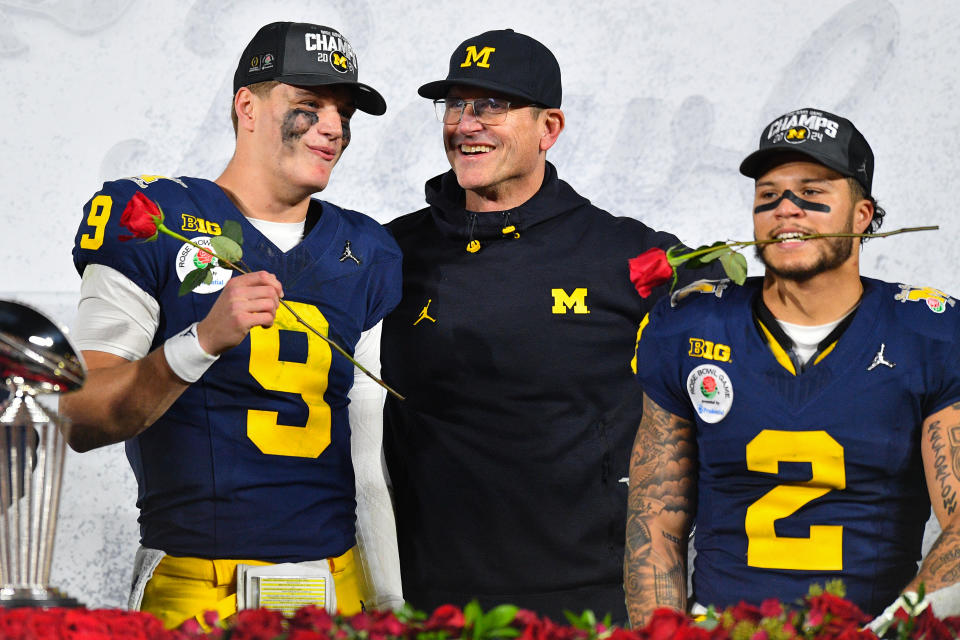 PASADENA, CA - JANUARY 01: QB J.J. McCarthy (9) of the Michigan Wolverines celebrates with Head Coach Jim Harbaugh and RB Blake Corum (2) after the Michigan Wolverines defeated the Alabama Crimson Tide in overtime of the CFP Semifinal at the Rose Bowl Game on January, 1, 2024, at the Rose Bowl Stadium in Pasadena, CA. (Photo by Chris Williams/Icon Sportswire via Getty Images)