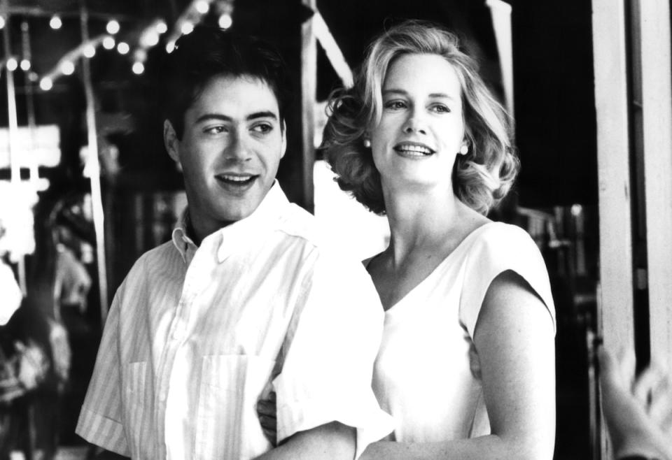 Robert Downey, Jr. is held by Cybill Shepherd in a scene from the film 'Chances Are', 1988