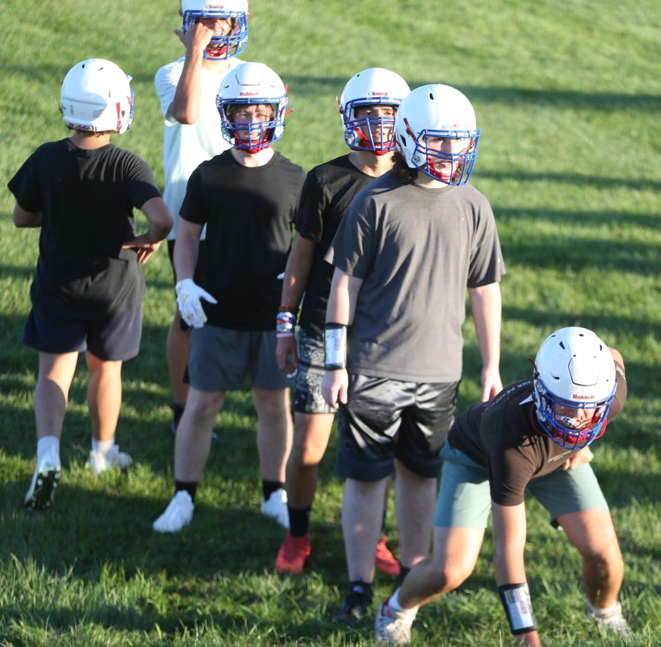 During the first day of fall 2023 practice, Winnacunnet High School football players go through drills Friday, Aug. 11 in Hampton.