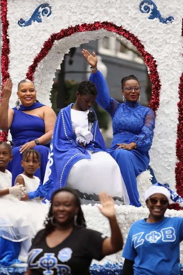 Zeta Phi Beta sorority members and family wave to paradegoers during the 2021 Rotary Christmas Parade in Fayetteville. Organizers say safety precautions are in place for this year's parade.