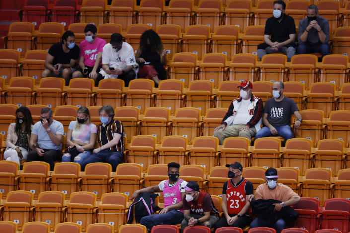 Fans look on during the fourth quarter between the Miami Heat and the Toronto Raptors at American Airlines Arena.