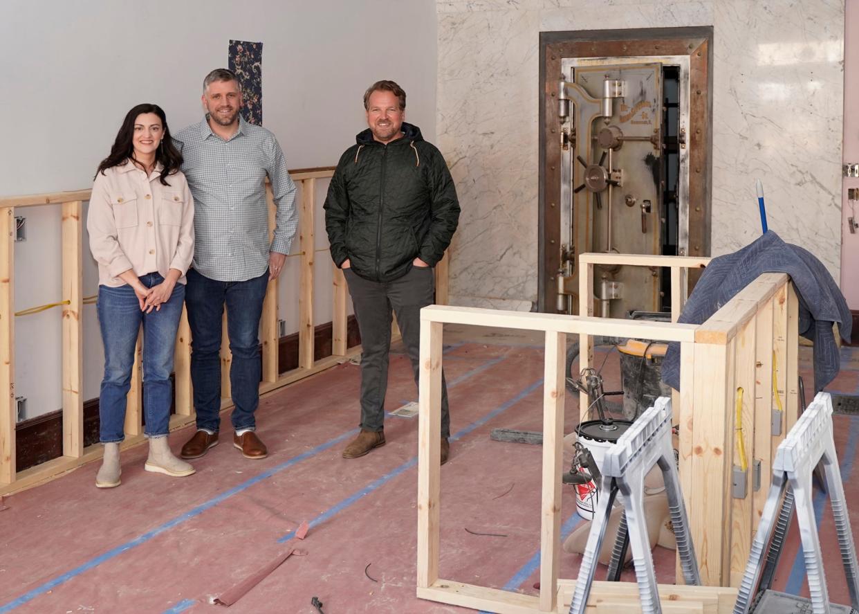 From left to right are business partners Elizabeth Gentry and Matt Cross, wife and husband, of Adrian, and Josh Roth of Tecumseh by the vault that is left in the building at 110 W. Chicago Blvd. from when Lilley State Bank was there. The partners are working on opening Harvest Chocolate and The Vault soon.