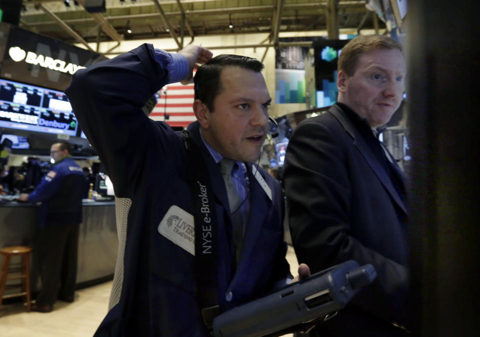 Trader Michael Zicchinolfi, left, works on the floor of the New York Stock Exchange, Monday, March 3, 2014. Global stock markets are down sharply on tensions over Russia's military advance into Ukraine and the threat of sanctions by Western governments. (AP Photo/Richard Drew)