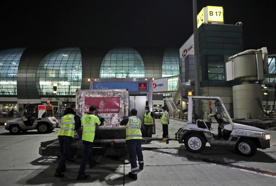 A shipment of Pfizer-BioNTech COVID-19 coronavirus vaccines is offloaded from an Emirates Airlines Boing 777 that arrived from Brussels to Dubai International Airport in Dubai, United Arab Emirates, Saturday, Feb. 20, 2021. As the coronavirus pandemic continues to clobber the aviation industry, Emirates Airlines, the Middle East’s biggest airline, is seeking to play a vital role in the global vaccine delivery effort. (AP Photo/Kamran Jebreili)