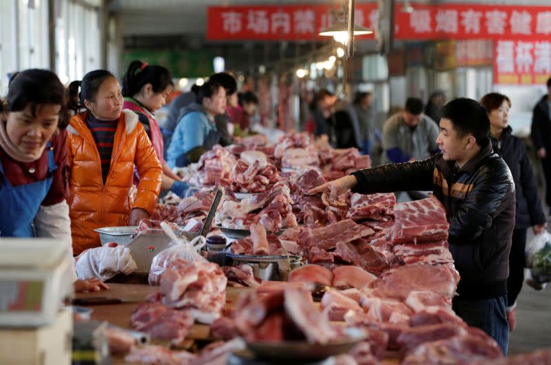 FILE PHOTO: Meat stalls are seen at a market in Beijing