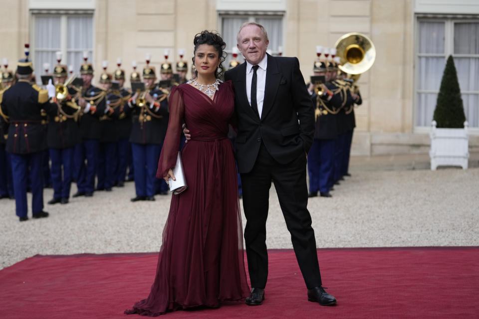 Salma Hayek and François-Henri Pinault, center, CEO of luxury group Kering, arrive to attend a state diner hosted by French President Emmanuel Macron for China's President Xi Jinping at the Elysee Palace, Monday, May 6, 2024 in Paris. (AP Photo/Thibault Camus)