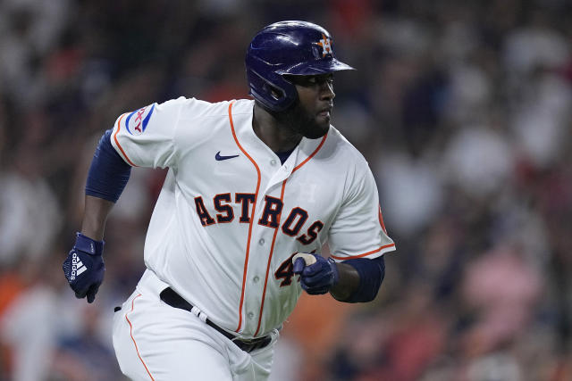 Yordan Alvarez of the Houston Astros high-fives with Mauricio