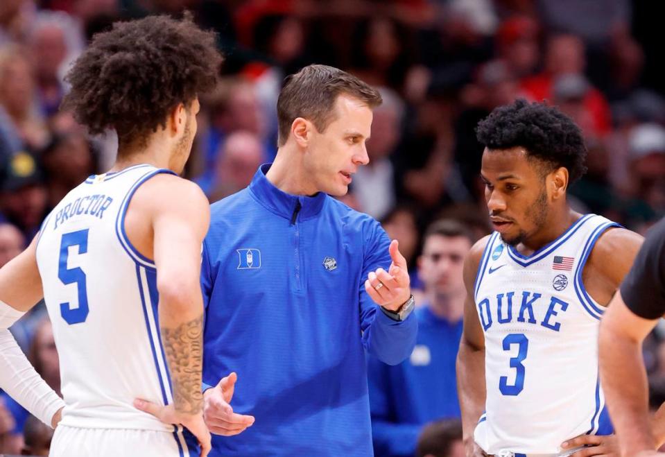 Duke’s head coach Jon Scheyer talks with Duke’s Tyrese Proctor (5) and Jeremy Roach (3) during the first half of N.C. State’s game against Duke in their NCAA Tournament Elite Eight matchup at the American Airlines Center in Dallas, Texas, Sunday, March 31, 2024.