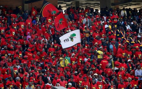 Members of South Africa's Economic Freedom Fighters party at the funeral - Credit: Reuters