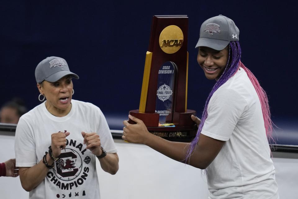 South Carolina head coach Dawn Staley and Aliyah Boston celebrate after a college basketball game in the final round of the Women's Final Four NCAA tournament against UConn Sunday, April 3, 2022, in Minneapolis. South Carolina won 64-49 to win the championship. (AP Photo/Charlie Neibergall)