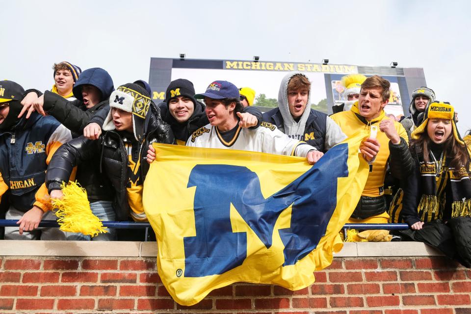 Michigan fans wave a Michigan flag during warmups before the Ohio State game at Michigan Stadium in Ann Arbor on Saturday, Nov. 25, 2023.
