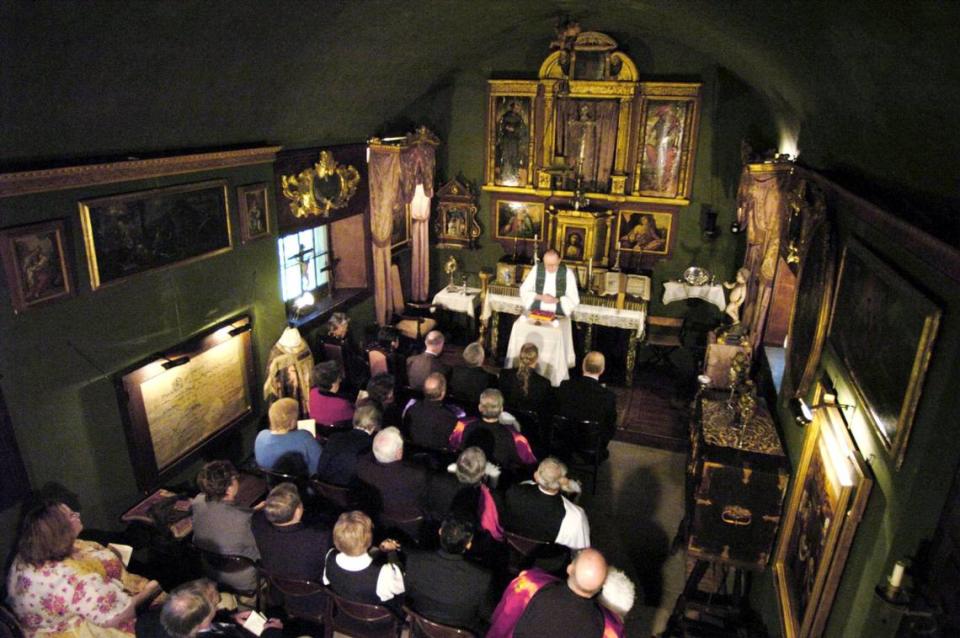 Monsignor Philip Saylor prays during the Columbus Day Mass at the Columbus Chapel in Boalsburg, Pa. October 11, 2004.