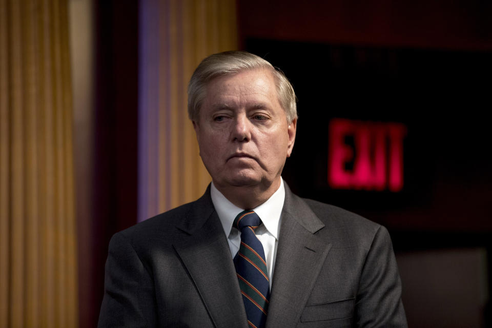FILE - In this March 25, 2020, file photo Sen. Lindsey Graham, R-S.C., listens during a news conference about the coronavirus relief bill on Capitol Hill in Washington. (AP Photo/Andrew Harnik, File)