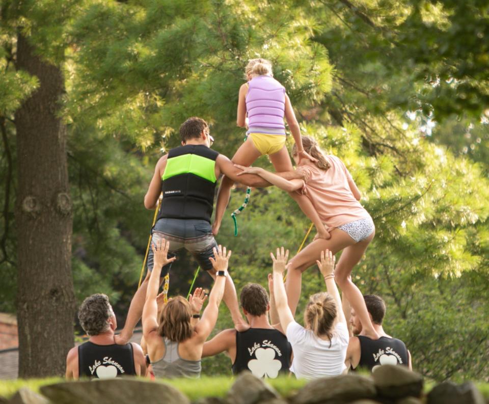 Members of the Lake Shannon Water Ski Club practice a pyramid from the stability of land before attempting it on waterskis Monday, Aug. 1, 2022.