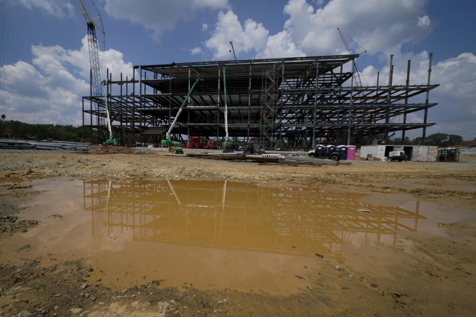 Construction personnel work on Carolina Panthers' state-of-the-art team headquarters and practice facility Tuesday, Aug. 24, 2021, in Rock Hill, S.C. "The Rock" will host all of the team's offices and training/locker room facilities, along with three outdoor grass practice fields, one indoor artificial field and another outdoor artificial field that is part of a 5,000-seat multipurpose stadium that can also be used to host high school football and soccer games, concerts, car shows and much more. (AP Photo/Chris Carlson)