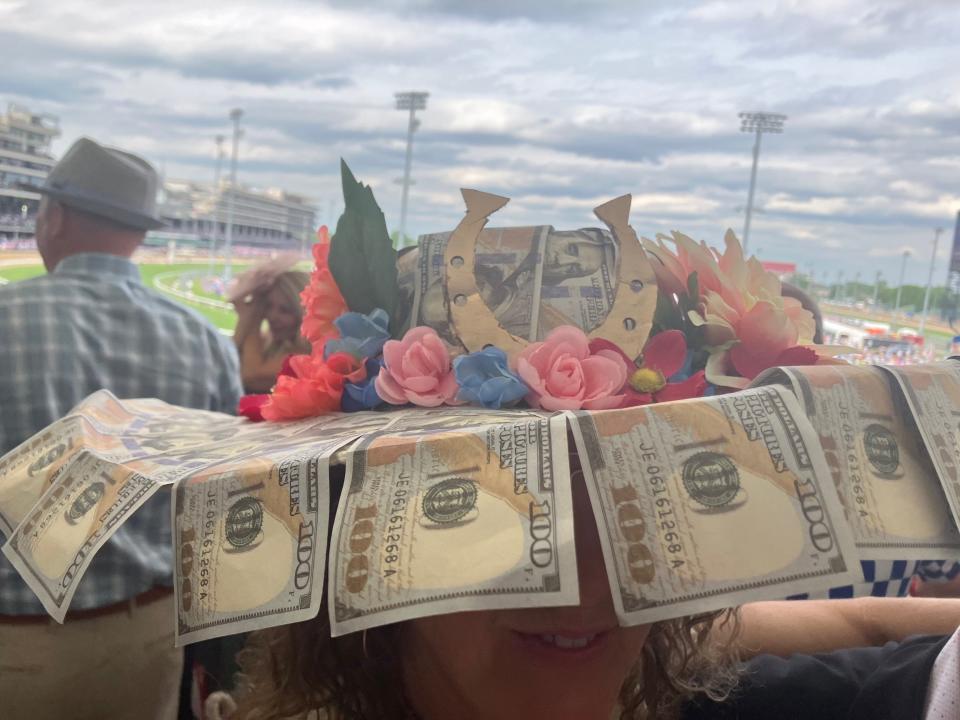 Kim Alvino shows off her Kentucky Derby hat, which was made from fake $100 bills, at Churchill Downs on Saturday, May 6, 2023.