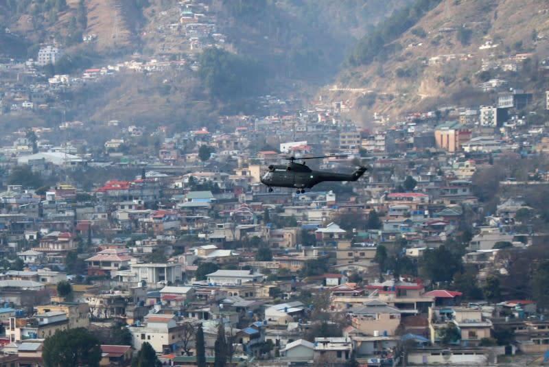 Helicopter, used to rescue and distribute relief goods among people in affected areas after a heavy snowfall, takes-off in Muzaffarabad