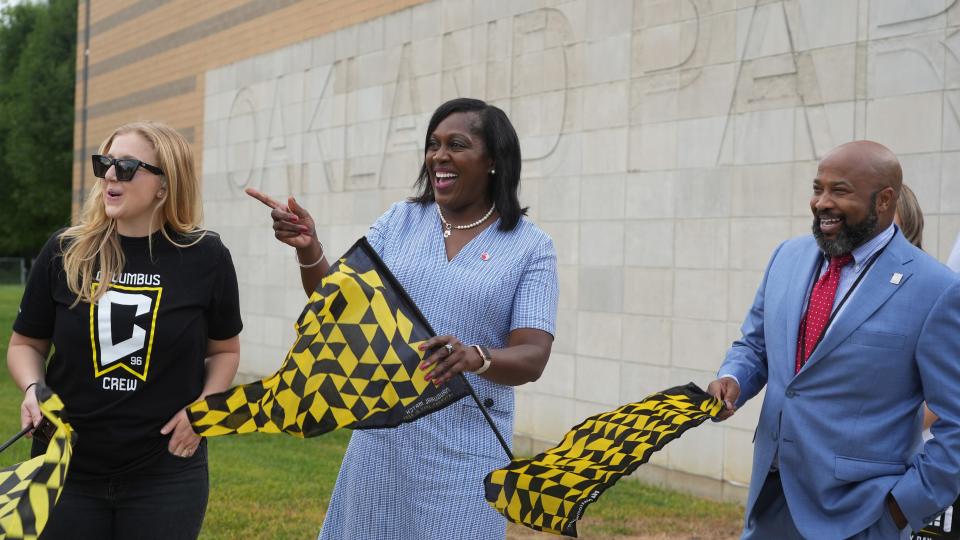Columbus City Schools Superintendent Talisa Dixon (center) watches students arrive at Oakland Park Alternative Elementary School on Aug. 29. At left is Columbus Crew staffer Heidi Dettmer and at right is the district's Region 6 Area Superintendent Luther E. Johnson, Jr.