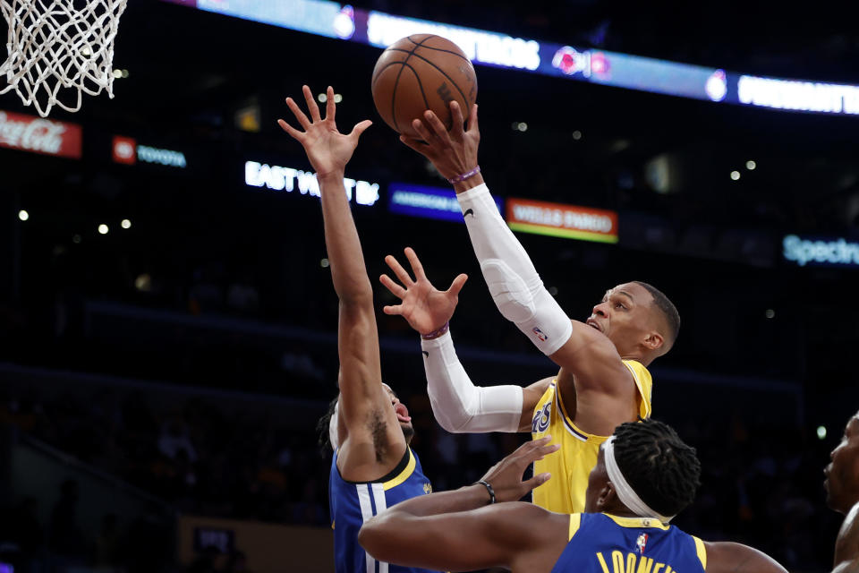 Los Angeles Lakers guard Russell Westbrook shoots as Golden State Warriors guard Moses Moody, rear, defends during the first half of an NBA basketball game in Los Angeles, Tuesday, Oct. 19, 2021. (AP Photo/Ringo H.W. Chiu)