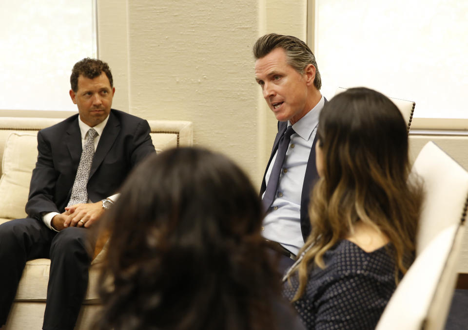 In this photo taken June 4, 2019, Gov. Gavin Newsom meets with a group of small business owners and government officials to discuss tax relief at his Capitol office in Sacramento, Calif. Lawmakers approved the state budget, Thursday, June 13, 2019, that includes an expansion of the state's earned income tax credit. Newsom wants to pay for it by adopting some of President Donald Trump's 2017 tax overhaul, but Assembly Democrats are cautious about this idea. (AP Photo/Rich Pedroncelli)