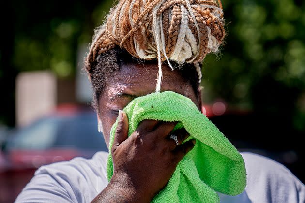 Nicole Brown wipes sweat from her face while setting up her beverage stand near the National Mall on July 22, 2022, in Washington. (Photo: AP Photo/Nathan Howard)