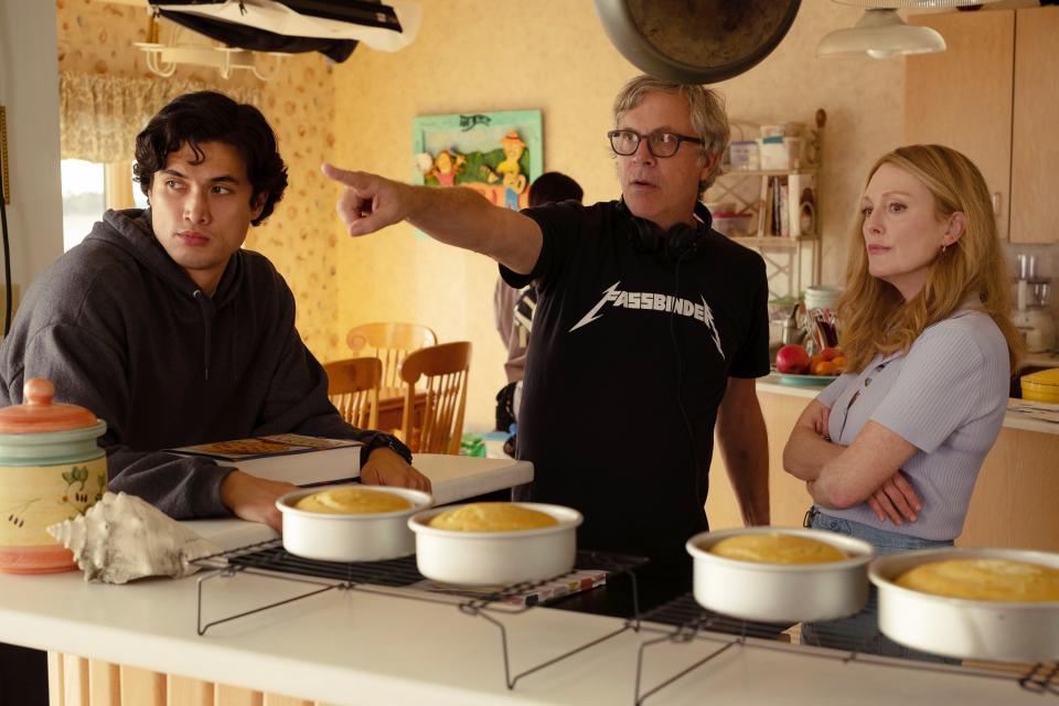 the director with the two actors on set in a kitchen