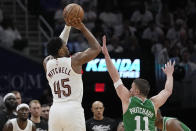 Cleveland Cavaliers guard Donovan Mitchell (45) shoots over Boston Celtics guard Payton Pritchard (11) during the second half of Game 3 of an NBA basketball second-round playoff series Saturday, May 11, 2024, in Cleveland. (AP Photo/Sue Ogrocki)